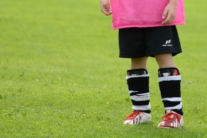 A photo of a boy in football kit.